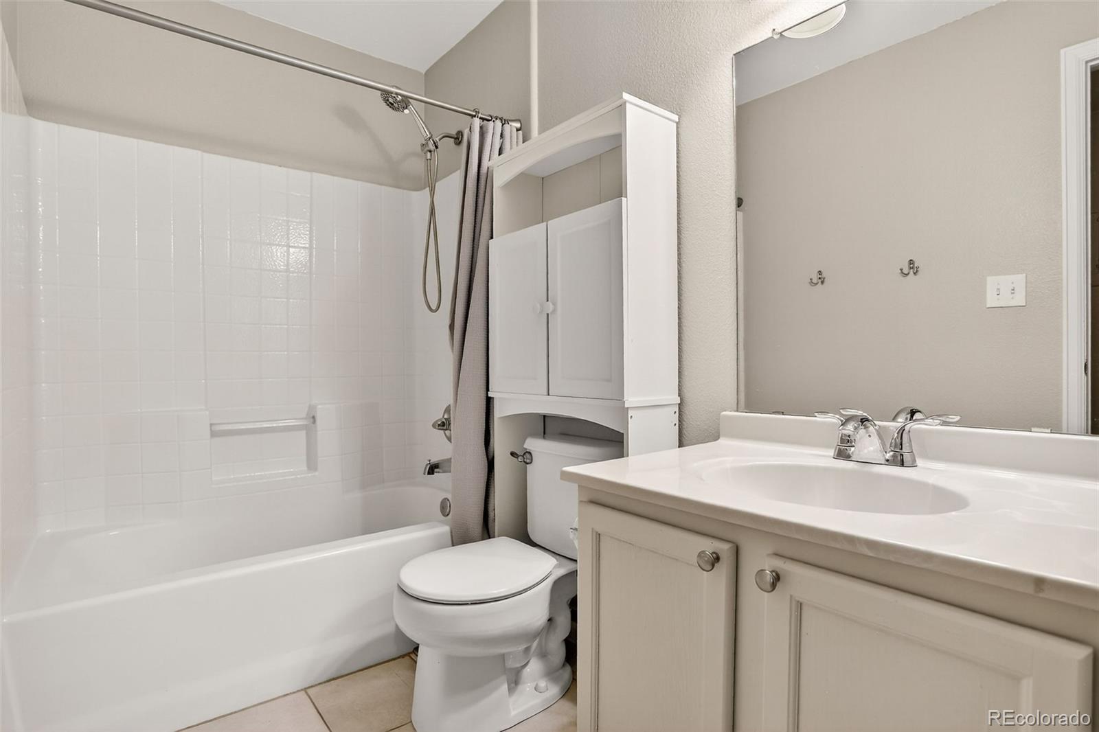 8415 Pebble Creek Way, Unit 203 Highlands Ranch, CO 80126 - Photo 22 of 36 a bathroom with a sink a toilet and shower