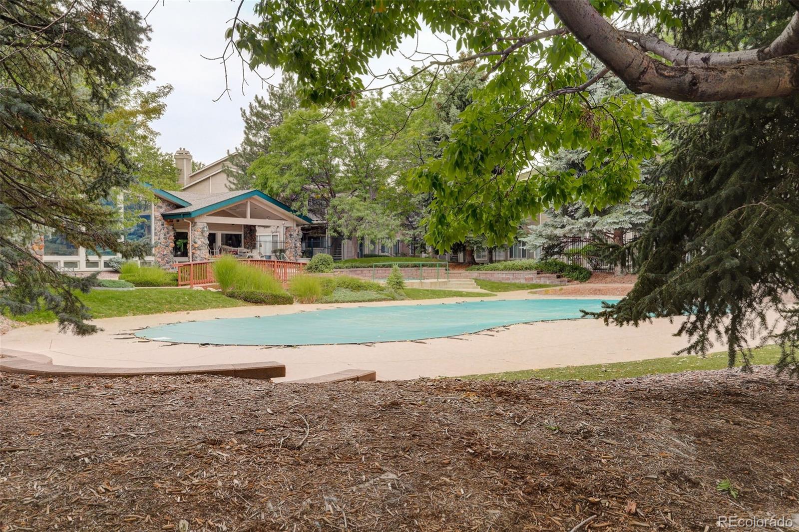 8415 Pebble Creek Way, Unit 203 Highlands Ranch, CO 80126 - Photo 32 of 36 a view of a house with a big yard and large trees