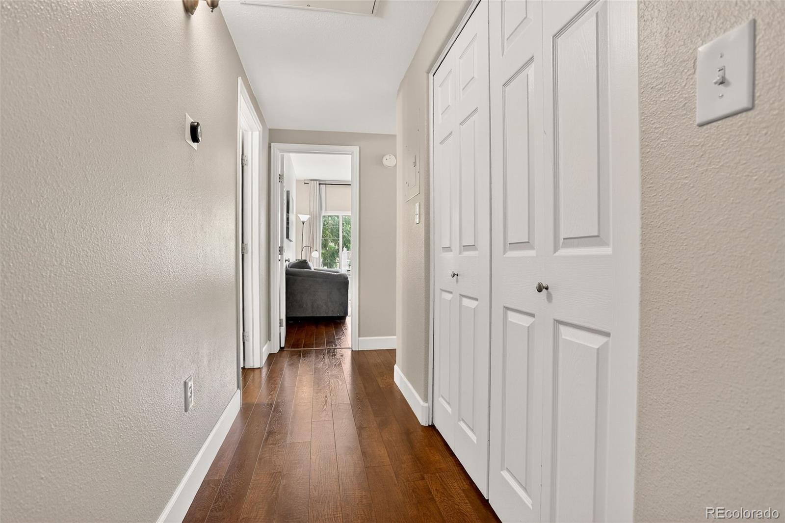 8415 Pebble Creek Way, Unit 203 Highlands Ranch, CO 80126 - Photo 4 of 36 a view of a hallway with wooden floor and closet