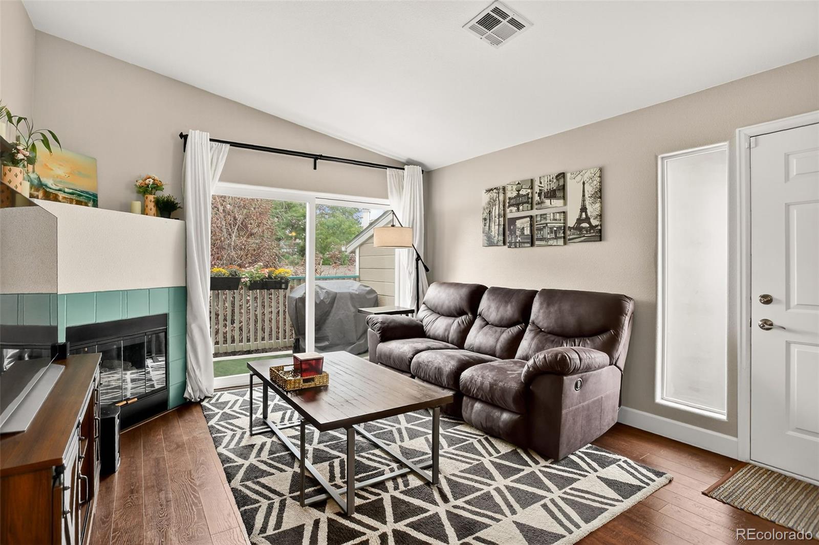 8415 Pebble Creek Way, Unit 203 Highlands Ranch, CO 80126 - Photo 7 of 36 a living room with furniture a fireplace and a table