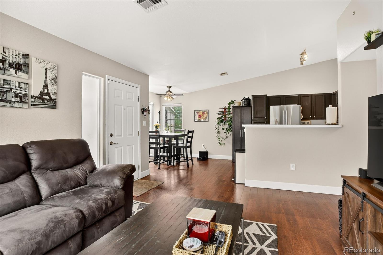8415 Pebble Creek Way, Unit 203 Highlands Ranch, CO 80126 - Photo 8 of 36 a living room with furniture and wooden floor