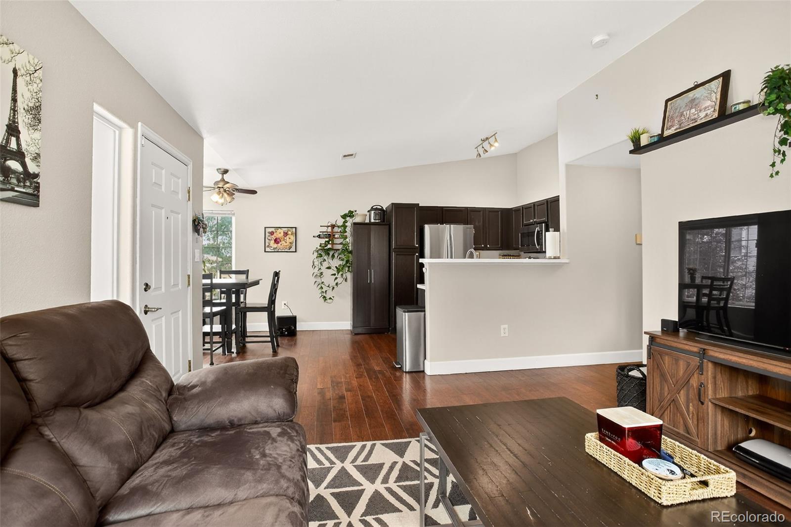 8415 Pebble Creek Way, Unit 203 Highlands Ranch, CO 80126 - Photo 9 of 36 a living room with furniture and wooden floor