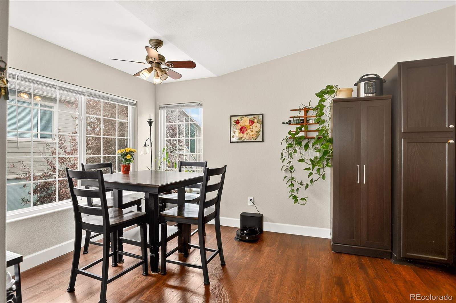 8415 Pebble Creek Way, Unit 203 Highlands Ranch, CO 80126 - Photo 10 of 36 a view of a dining room with furniture window and wooden floor