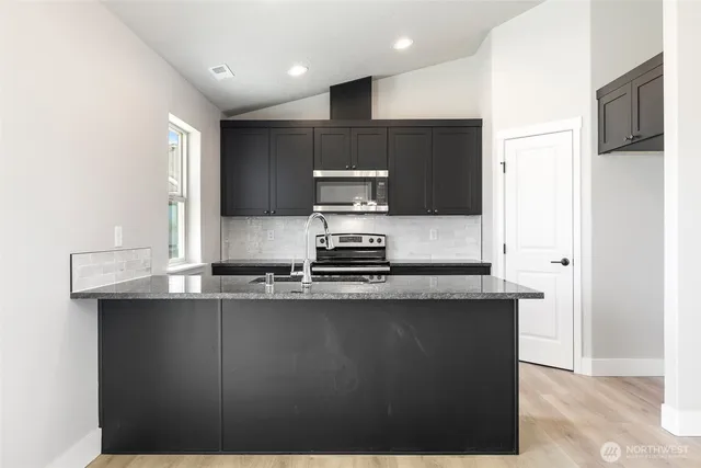 a kitchen with a sink and a refrigerator
