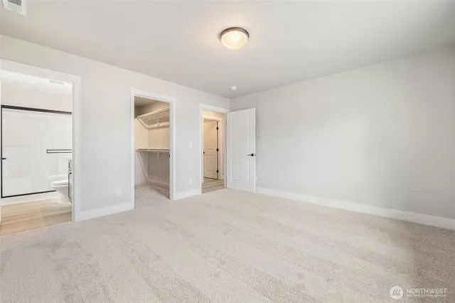 an empty room with an entryway and door