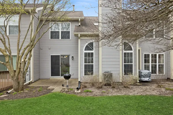 a view of a house with a yard and sitting area