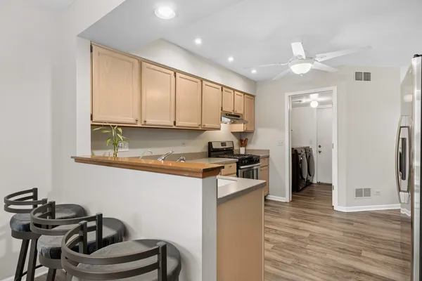 a kitchen with stainless steel appliances granite countertop a stove refrigerator and a microwave