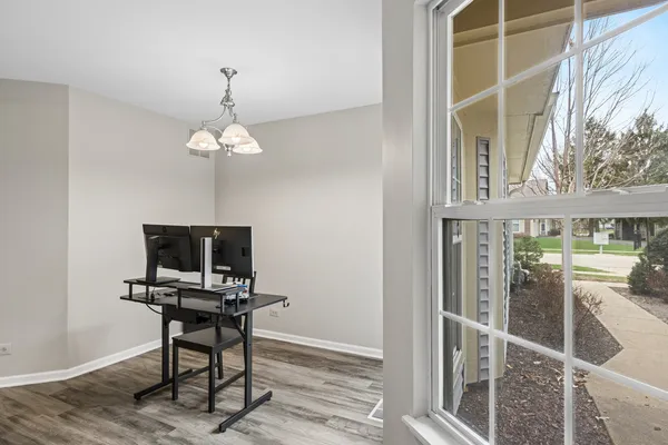 a view of a workspace with furniture and a window