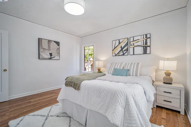 a bedroom with a bed and a painting on the wall