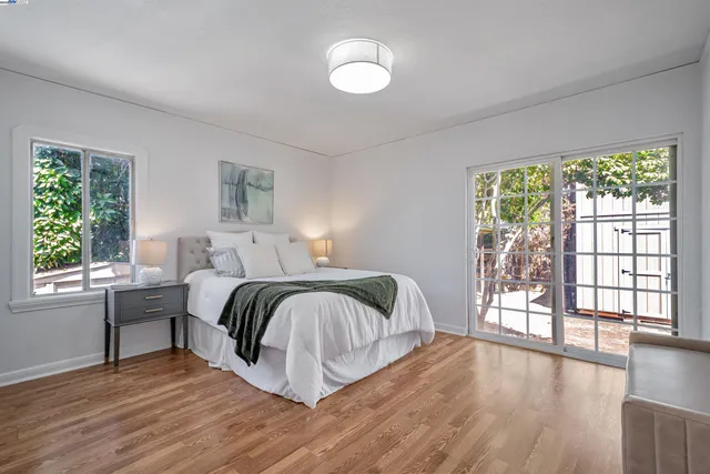 a bedroom with a bed and a large window