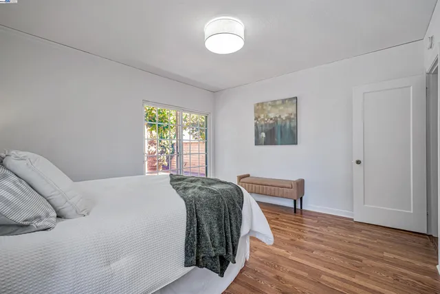 a bedroom with a bed and a window