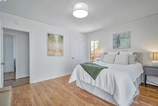 a spacious bedroom with a bed and a window