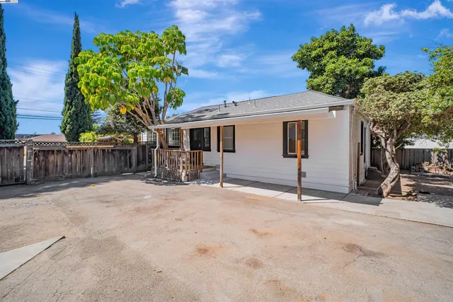 a view of a house with a backyard and a garage