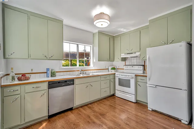 a kitchen with a white cabinets and white appliances