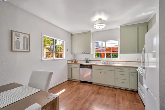 a kitchen with a sink cabinets and wooden floor