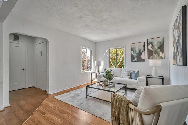 a living room with furniture and wooden floor