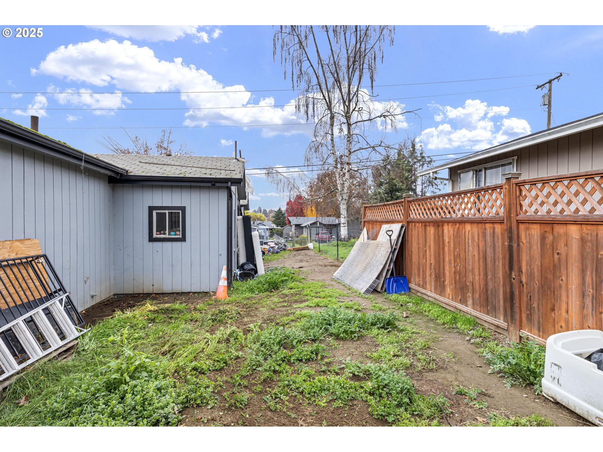 350 Park Street Winston, OR 97496 - Photo 23 of 25 a view of a backyard with brick wall and potted plants