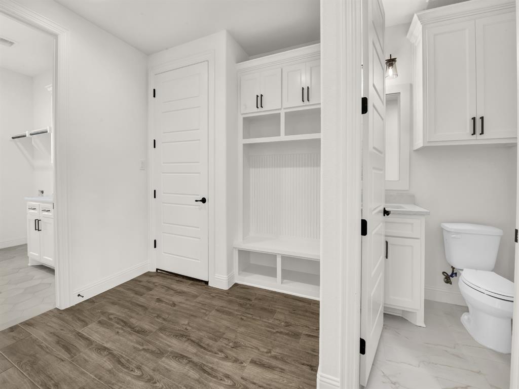 143 Desperado Way Weatherford, TX 76088 - Photo 28 of 36 Mudroom with baseboards and wood finished floors