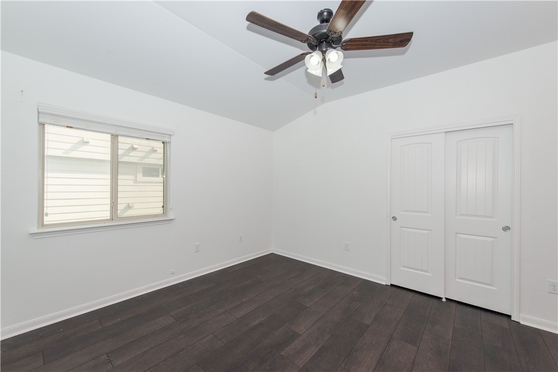 1007 Plateau Trail Georgetown, TX 78626 - Photo 20 of 32 an empty room with wooden floor fan and windows