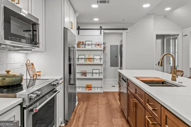 a kitchen with stainless steel appliances granite countertop a sink stove and refrigerator