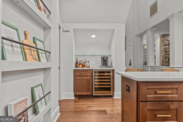 a view of kitchen with cabinets and window