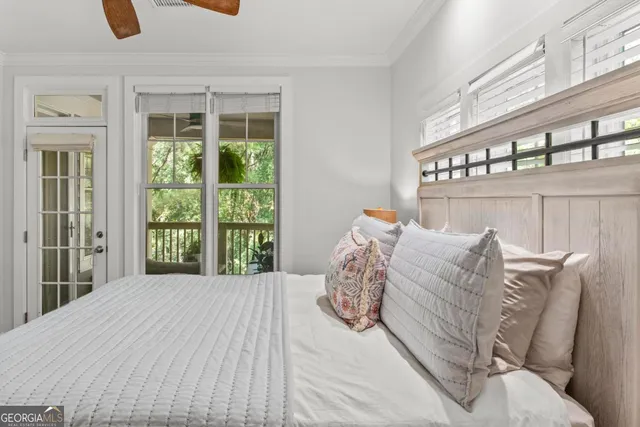 a bed sitting in a bedroom next to a window