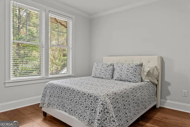a large bed sitting in a bedroom next to a window