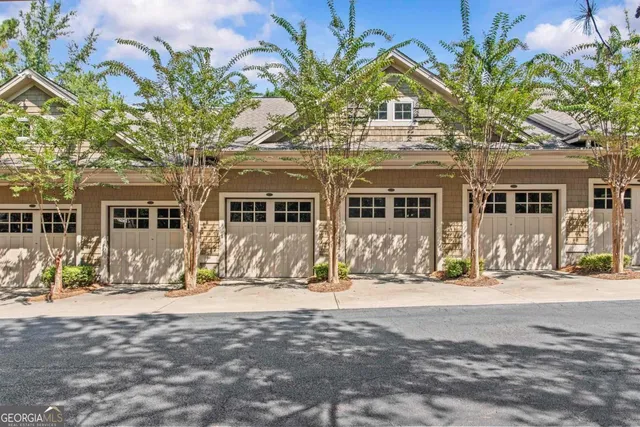 a view of a house with a tree in front