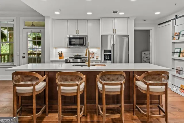 a kitchen with granite countertop a counter space cabinets stainless steel appliances and cabinets