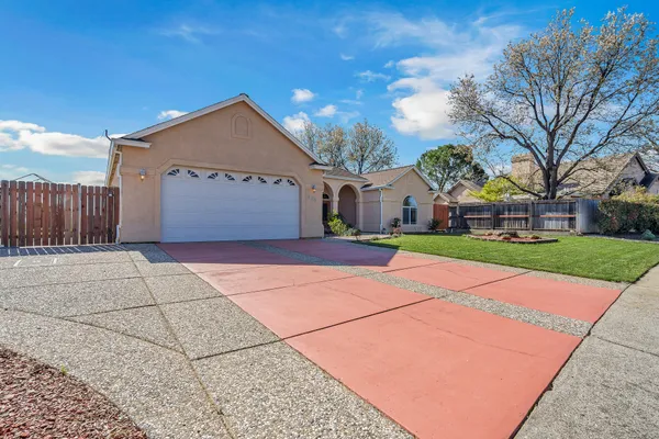 a kitchen with granite countertop wooden cabinets stainless steel appliances and a sink