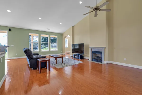 a view of a livingroom with wooden floor and a window