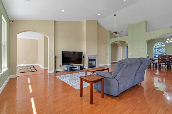 a view of a dining room with furniture chandelier and wooden floor