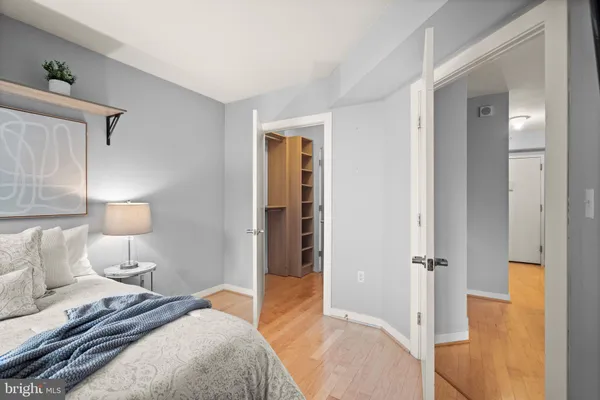 a bedroom with a bed and a lamp