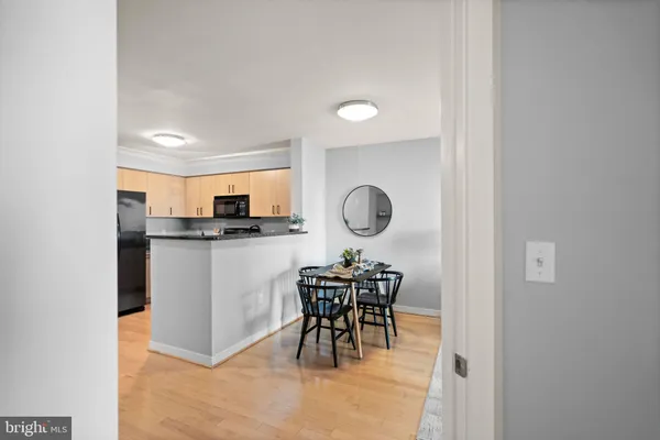 a kitchen with stainless steel appliances kitchen island a table and chairs in it