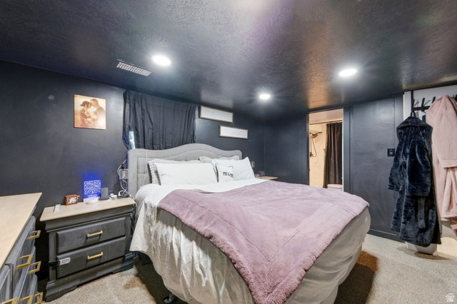 2323 North 720 West Clinton, UT 84015 - Photo 21 of 34 Bedroom with light colored carpet, a textured ceiling, recessed lighting, and connected bathroom