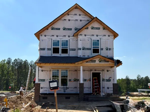 a front view of a house with parking space