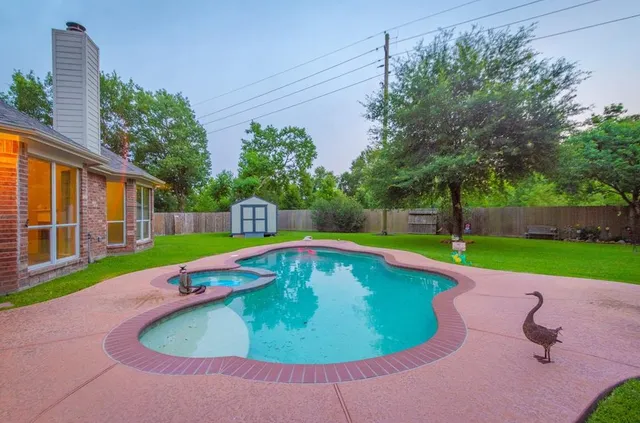 a view of a swimming pool with a backyard