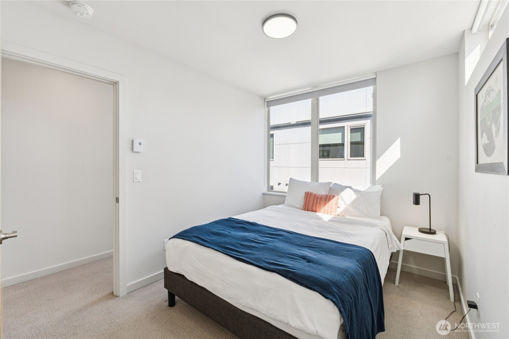 1432 South King Street Seattle, WA 98144 - Photo 14 of 28 a bedroom with a bed and a large window