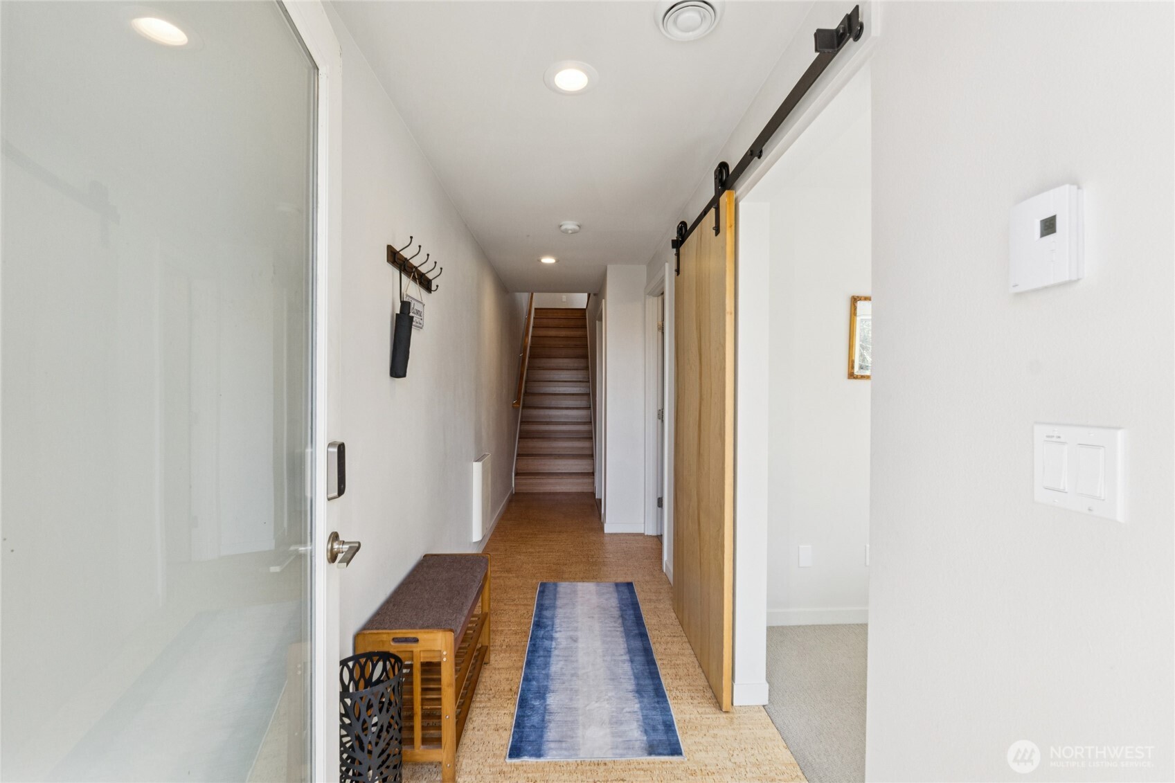 1432 South King Street Seattle, WA 98144 - Photo 2 of 28 a view of a hallway with wooden floor and staircase