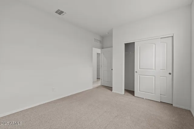 a view of an empty room and entryway