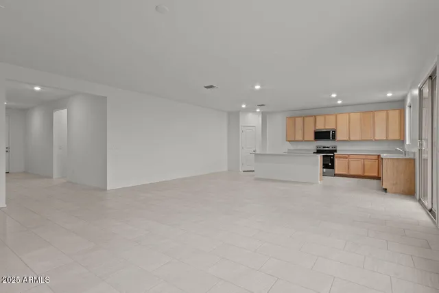 a view of kitchen with kitchen island and windows