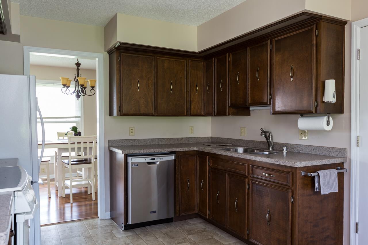 The kitchen has good cabinet storage space. The door to the left of the photo is the entrance to the dining room - convenient for meal service and clean up.