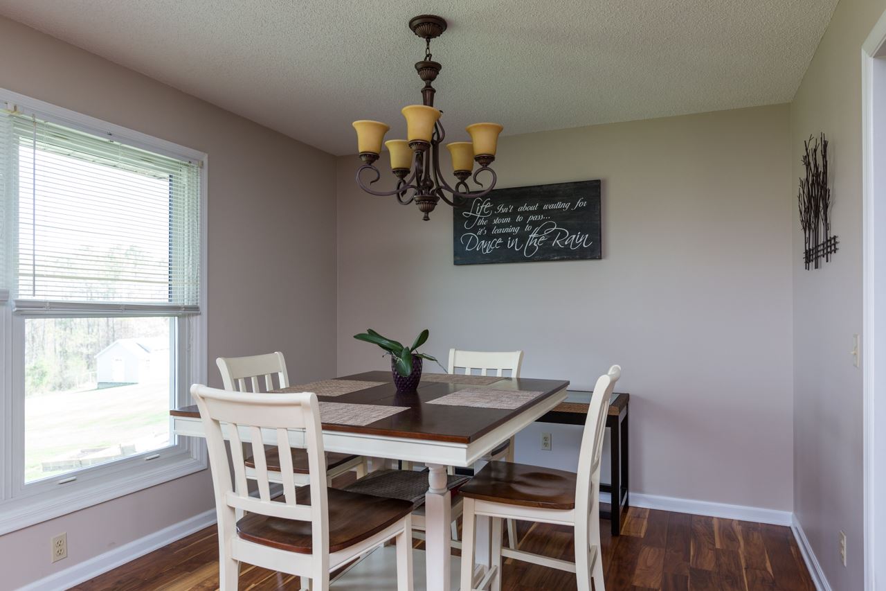 A sunny dining room with beautiful laminate flooring.