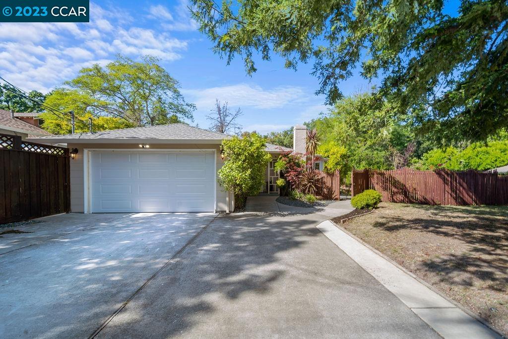 a backyard of a house with plants and trees