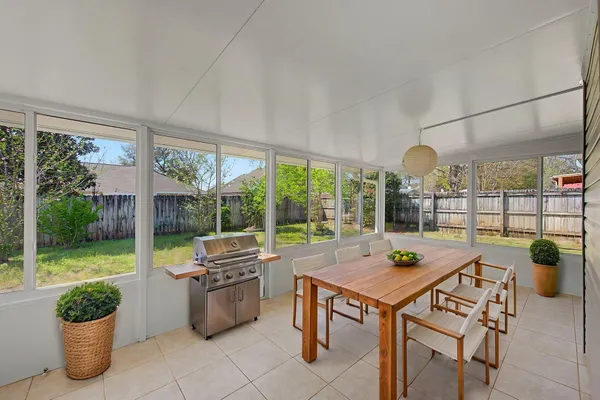 a view of a patio with a dining table and chairs