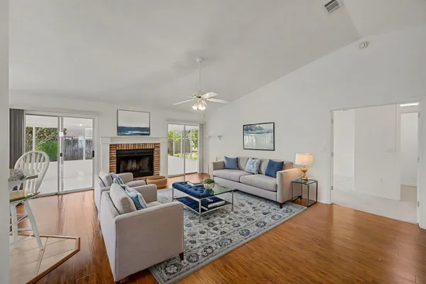 a living room with furniture a fireplace and a flat screen tv