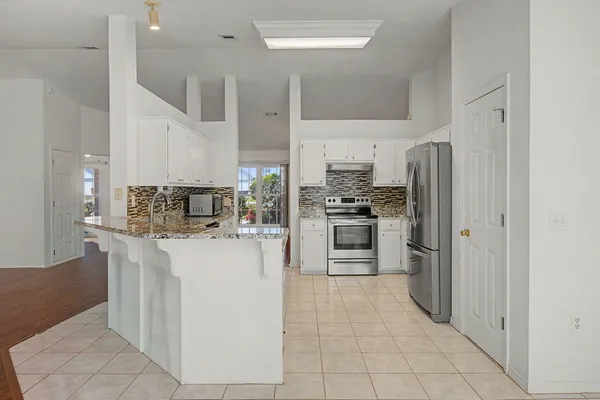 a kitchen with stainless steel appliances a refrigerator stove and sink