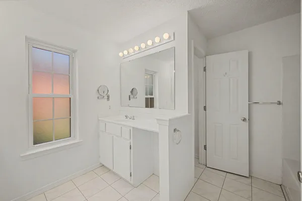 a bathroom with a sink a mirror and a vanity