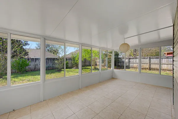 a view of an empty room with windows