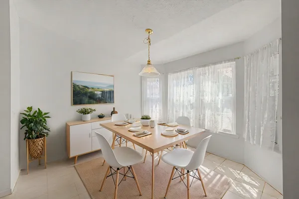 a dining room with furniture window and outside view